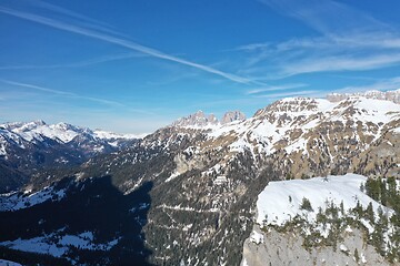 Image showing aerial snow covered mountain peaks in alps at winter 