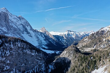 Image showing aerial snow covered mountain peaks in alps at winter 