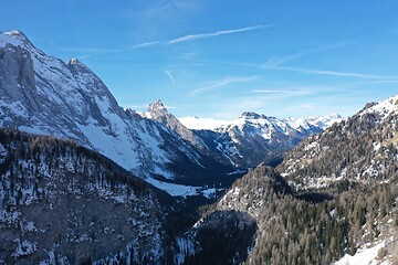 Image showing aerial snow covered mountain peaks in alps at winter 