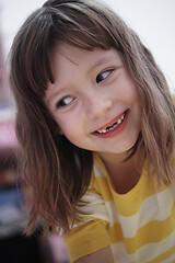 Image showing cute little girl at home painting with hands