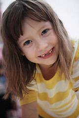 Image showing cute little girl at home painting with hands