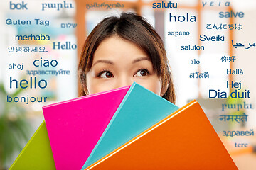 Image showing asian woman or student hiding behind notebooks