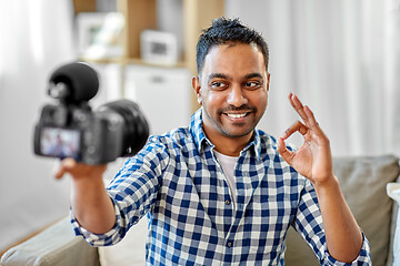 Image showing male video blogger with camera blogging at home