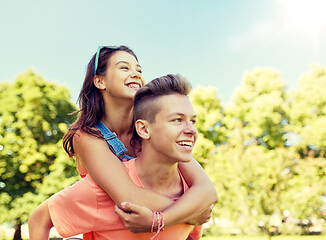 Image showing happy teenage couple having fun at summer park