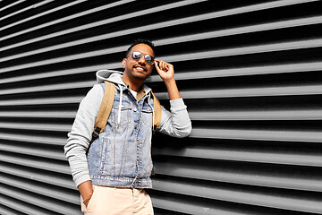 Image showing indian man in sunglasses with backpack on street