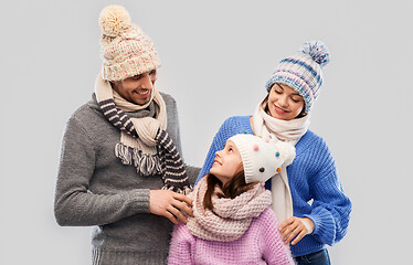 Image showing happy family in winter clothes on grey background