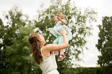 Image showing happy mother with baby daughter at summer park