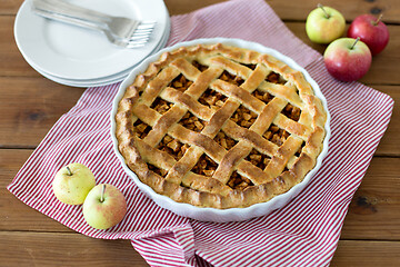 Image showing apple pie in baking mold on wooden table