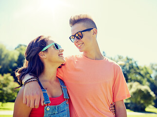 Image showing happy teenage couple looking at each other in park