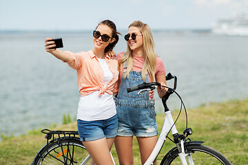 Image showing teenage girls with bicycle taking selfie in summer