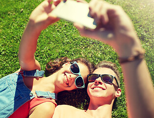 Image showing happy couple taking selfie on smartphone at summer