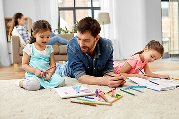 Image showing father spending time with little daughters at home