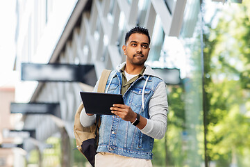 Image showing man with tablet pc and backpack on city street