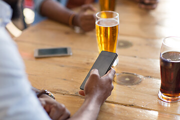 Image showing man with smartphone drinking beer at bar or pub