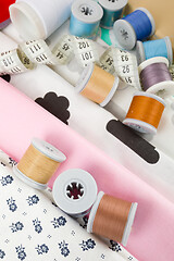 Image showing fabric, tailor measurement tape and thread spools