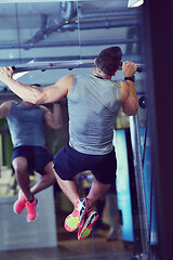 Image showing handsome man exercising at the gym