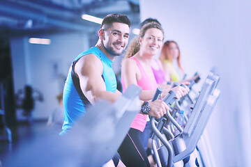 Image showing Group of people running on treadmills