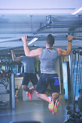 Image showing handsome man exercising at the gym