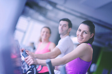 Image showing Group of people running on treadmills