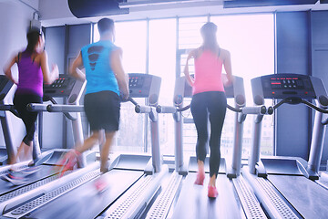 Image showing Group of people running on treadmills