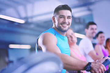 Image showing Group of people running on treadmills