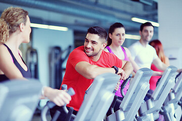 Image showing Group of people running on treadmills