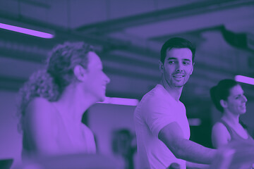 Image showing Group of people running on treadmills