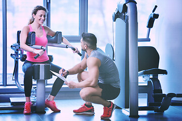 Image showing woman exercising with her personal trainer