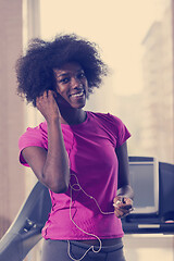 Image showing afro american woman running on a treadmill