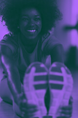 Image showing woman in a gym stretching and warming up before workout