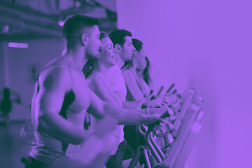 Image showing Group of people running on treadmills