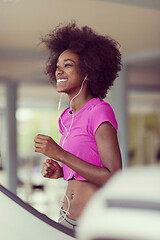 Image showing afro american woman running on a treadmill