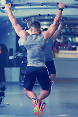 Image showing handsome man exercising at the gym