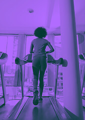 Image showing afro american woman running on a treadmill