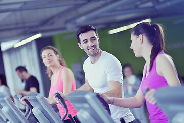 Image showing Group of people running on treadmills