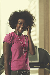 Image showing afro american woman running on a treadmill