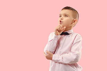 Image showing The teen boy whispering a secret behind her hand over pink background