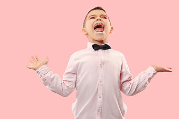 Image showing Isolated on pink young casual boy shouting at studio