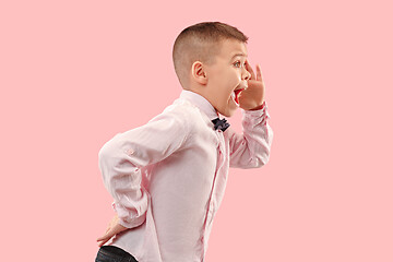 Image showing Isolated on pink young casual boy shouting at studio