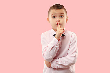 Image showing The teen boy whispering a secret behind her hand over pink background