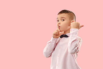 Image showing The teen boy whispering a secret behind her hand over pink background