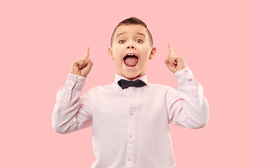 Image showing Isolated on pink young casual boy shouting at studio