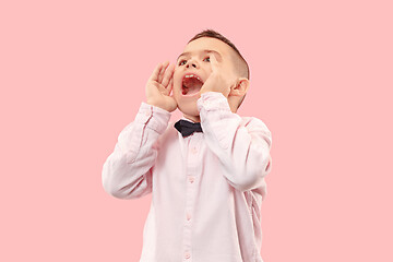 Image showing Isolated on pink young casual boy shouting at studio