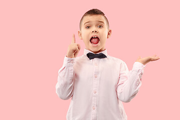 Image showing Isolated on pink young casual boy shouting at studio