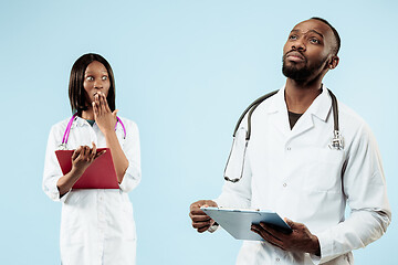 Image showing The female and male happy afro american doctors on blue background