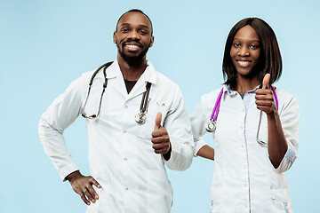 Image showing The female and male happy afro american doctors on blue background