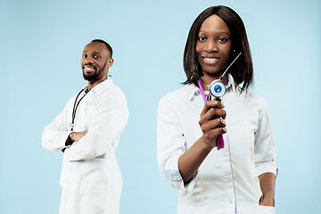 Image showing The female and male happy afro american doctors on blue background