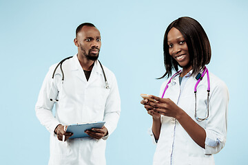 Image showing The female and male happy afro american doctors on blue background