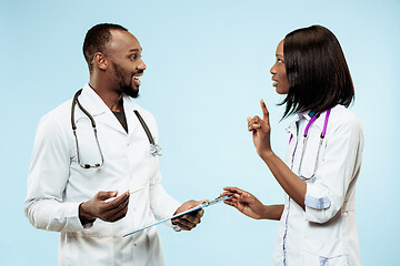 Image showing The female and male happy afro american doctors on blue background