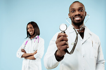 Image showing The female and male happy afro american doctors on blue background